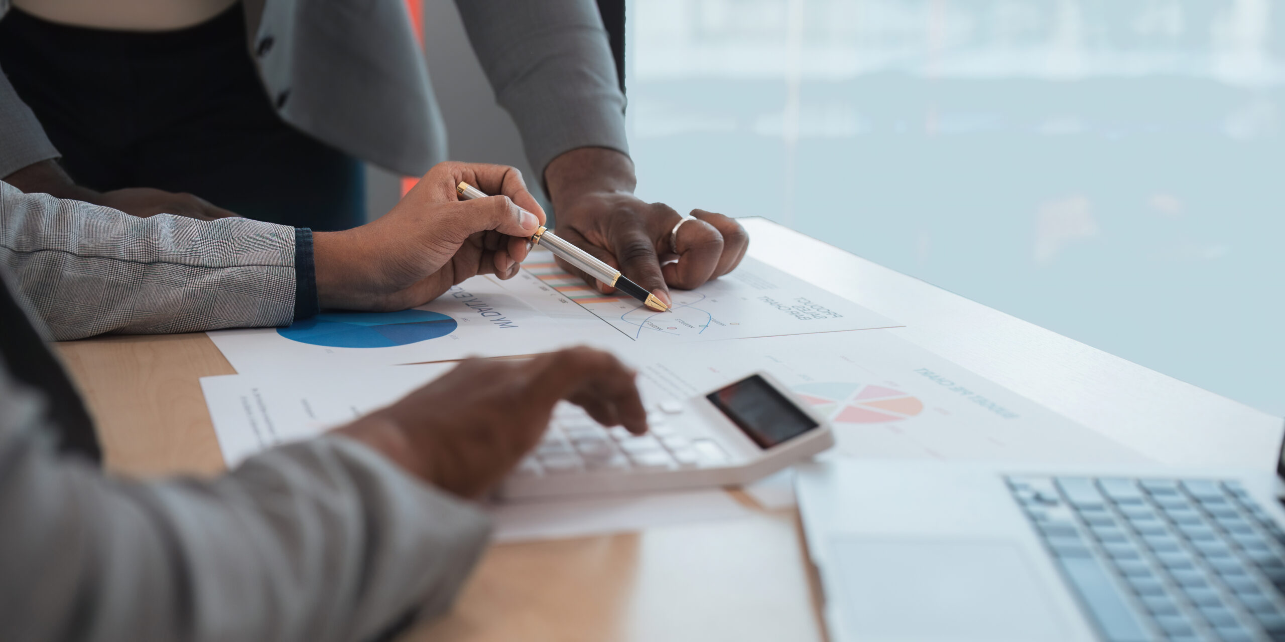 Group business diverse ethnicity on analysis financial data report paper on meeting table at office