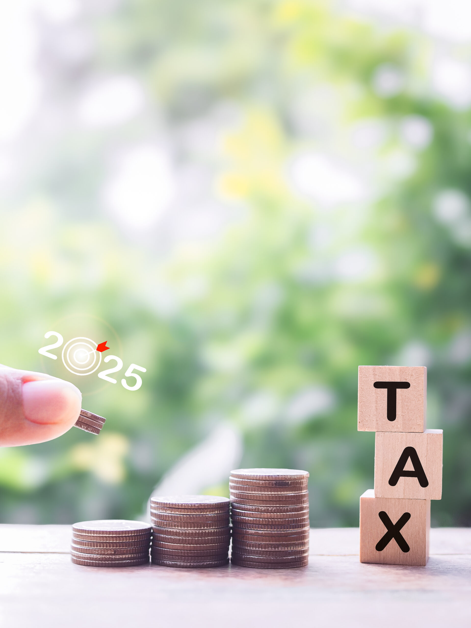 vecteezy_close-up-hand-putting-coin-into-stack-of-coins-and-wooden_50104727